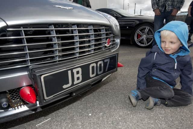 Three-year-old Finnan Seddon, of Farsley, inspecting a well-known number plate.