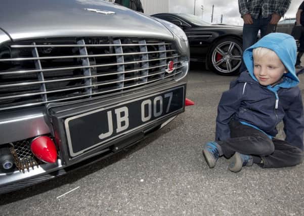 Three-year-old  Finnan Seddon, of Farsley, inspecting  a well-known number plate.