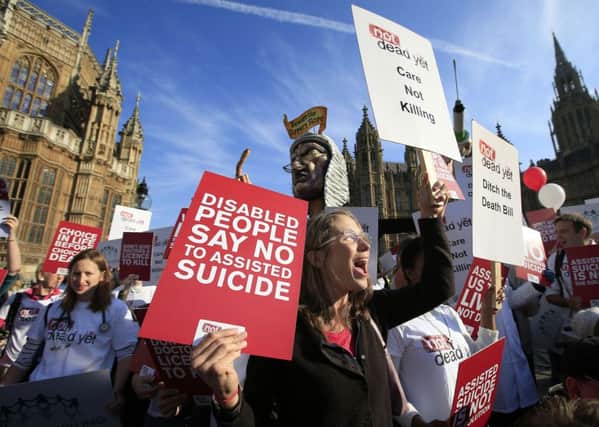 Protesters outside the Houses of Parliament as MPs debate and vote on the Assisted Dying Bill.