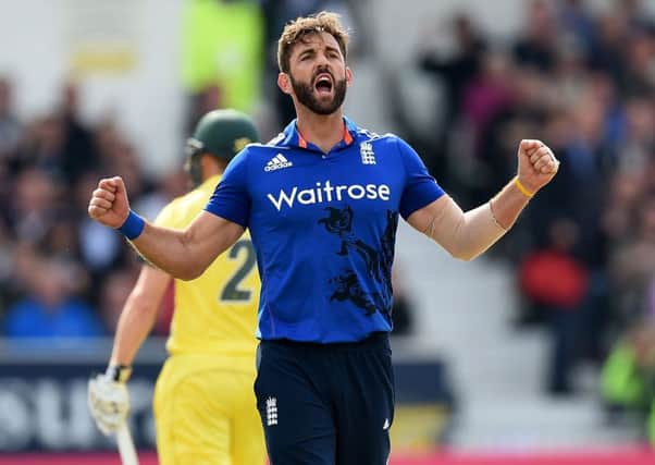 England's Liam Plunkett celebrates taking the wicket of Australia's Mitchell Marsh.