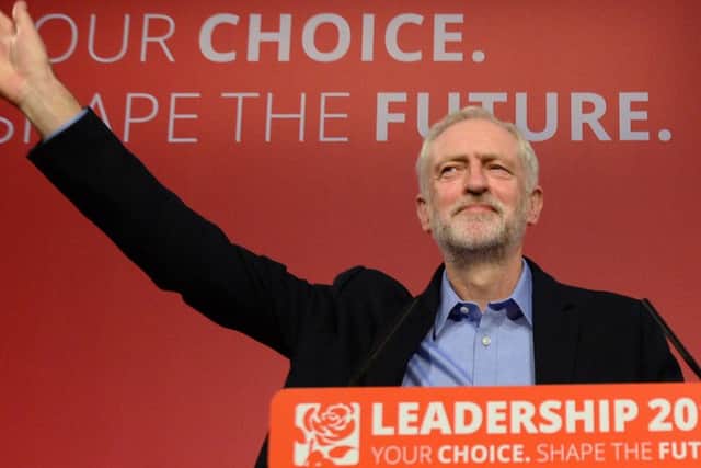 Jeremy Corbyn takes to the stage after he was announced as the Labour Party's new leader at a special conference at the QEII Centre in London. Photo: PA Wire