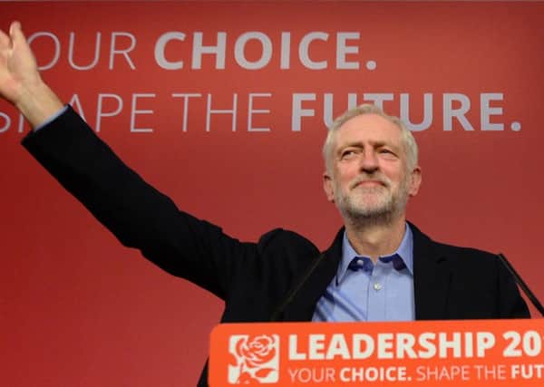 Jeremy Corbyn takes to the stage after he was announced as the Labour Party's new leader at a special conference at the QEII Centre in London. Photo: PA Wire