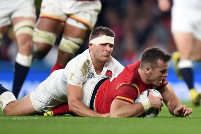 Wales' Gareth Davies dives in to score a try during the Rugby World Cup match at Twickenham Stadium, London.