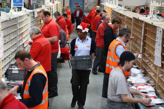 Royal Mail workers sorting the Christmas mail.