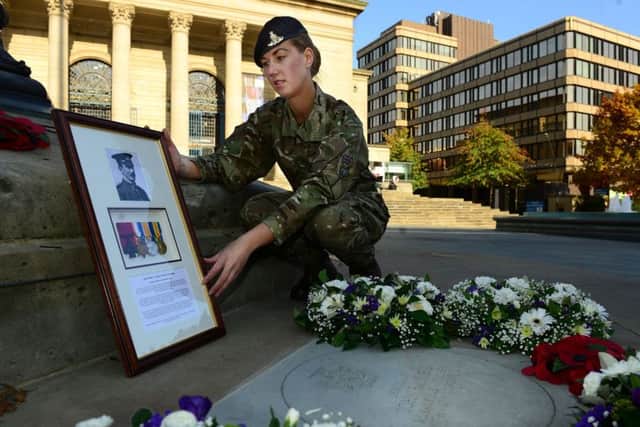 Gunner Kirsty Fildes with the plaque in honour of Sergeant Major John Crawshaw Raynes at the Cenotaph in Barkers Pool, Sheffield. Picture by Scott Merrylees.