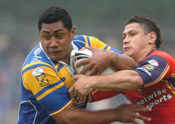 24th June 2005.  Leeds Rhinos Ali Lauitiiti is held by Danny Williams and Tyrone Smith in the Powergen Challenge Cup Quarter Final against the London Broncos at Headingley.