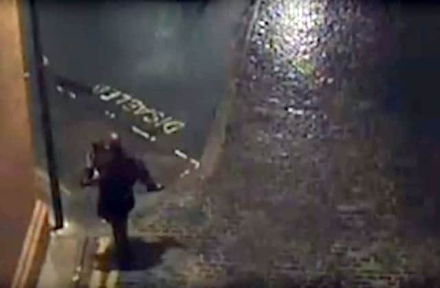 A still image from the CCTV showing the rapist carrying his victim before the attack