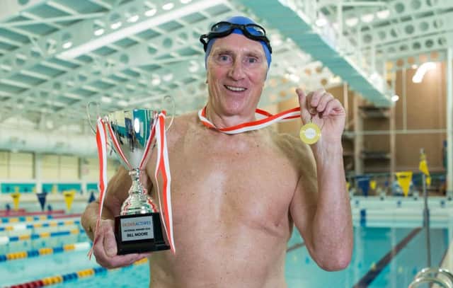 Bill Moore (R), 78, holds his trophy and medal after being crowned the UK's overall Older Actives Champion of 2015, pictured at the Aquatics Centre, at the John Charles Centre for Sport, Leeds, West Yorkshire, on 22 October 2015.