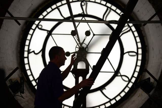 Premises manager Nick Tyas makes an adjustment to the Wakefield Town Hall clock as Daylight Saving Time ends at 2am on Sunday 25 October. Picture: Scott Merrylees