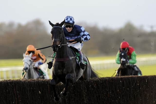 Menorah and Richard Johnson jump the last fence as they go on and win the bet365 Charlie Hall Chase