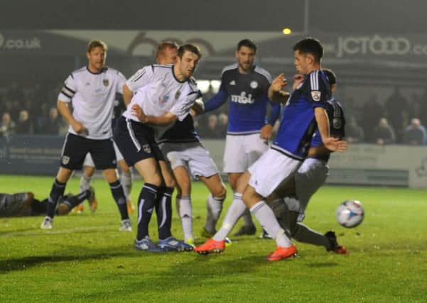 Adam Boyes scores for Guiseley but FC Halifax went on to win in extra-time (Picture: Steve Riding).