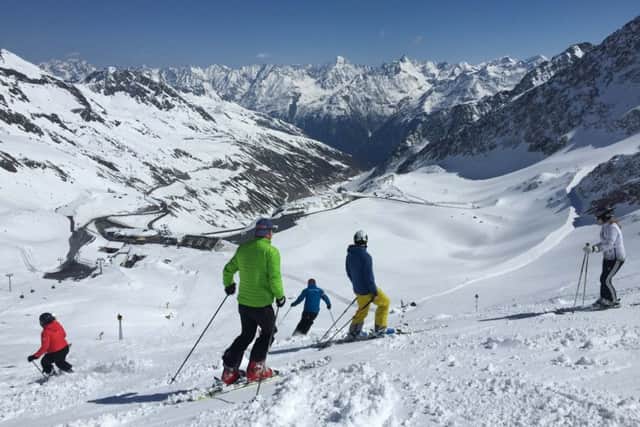 Skiers looking down the Oetz Valley from the glacier.