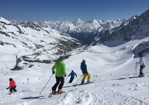 Skiers looking down the Oetz Valley from the glacier.