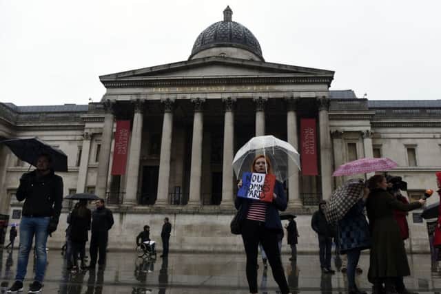 People attend a vigil in Trafalgar Square in London