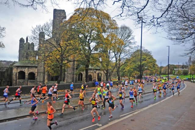 Runners make their way past Kirkstall Abbey on the Leeds Abbey Dash run. Pictures: Tony Johnson and James Hardisty