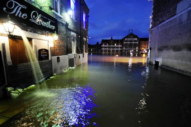 Riverside properties in York city centre pump out flood water as the River Ouse continues to rise after several days of torrential rain.