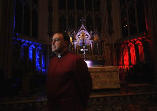 Canon Sam Corley at Leeds Minster which was decorated with the colours of the Tricolor - the French flag - for a service in honour of those affected by the Paris attacks. SH100142415a Pic: Simon Hulme.