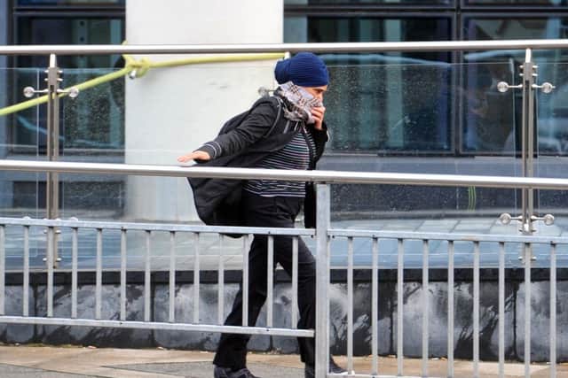 29 November 2015 .......         A pedestrian battles the blustery winds around Bridgewater Place in Leeds. Picture Tony Johnson