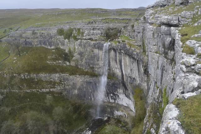 Water falls over the cliffs at Malham Cove, North Yorkshire, for the first time in a hundred years following heavy rain in the area. Picture: Jim Sputnik/PA Wire
