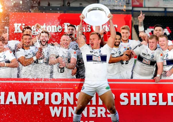 Featherstones Rovers' Ben Blackmore, holding up the Championship Shield trophy infront of his team-mates. PICTURE: James Hardisty