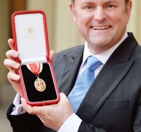 Sir Gary Verity holds his insignia of Knighthood which was presented by the Prince of Wales at the Investiture ceremony in Buckingham Palace, London.