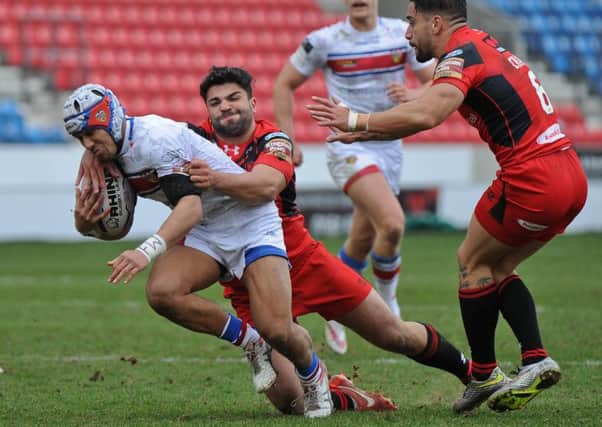 Jason Walton makes a tackle for Salford against his new club Wakefield.