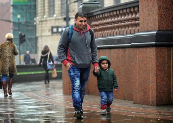 Syrian refugee Imad pictured with his son Reda, aged 3, at City Square, Leeds. Picture by Simon Hulme.