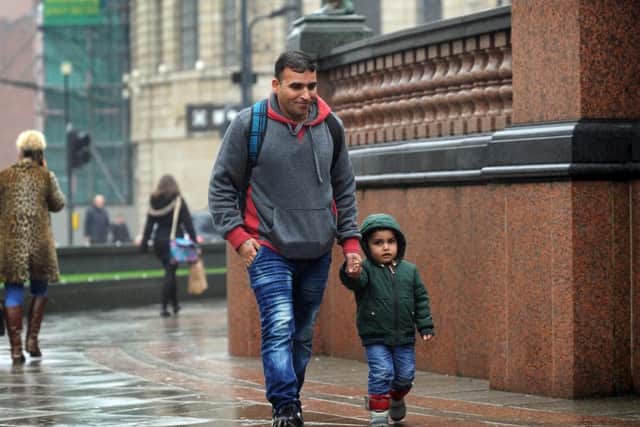 Syrian refugee Imad pictured with his son Reda aged 3, at City Square, Leeds. Imad's is the first family to arrive in Leeds as part of the UK resettlement scheme. Picture by Simon Hulme