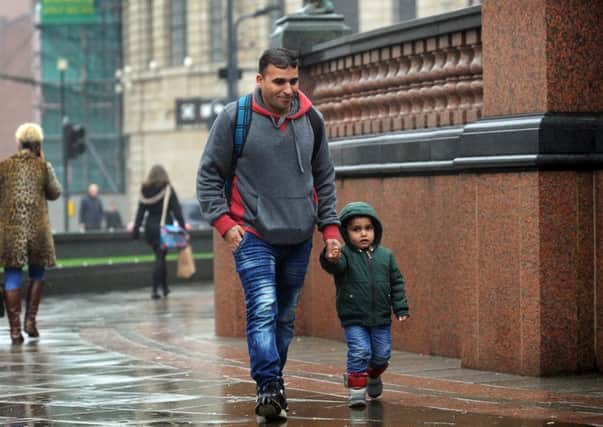 Syrian refugee Imad pictured with his son Reda aged 3, at City Square, Leeds. Imad's is the first family to arrive in Leeds as part of the UK resettlement scheme. Picture by Simon Hulme
