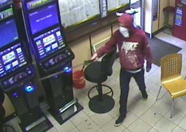 Police have released CCTV images of a man who brandished a samurai sword in an attempted robbery the William Hill shop, in Ring Road, Lower Wortley, at 10.35am on Saturday December 19.
