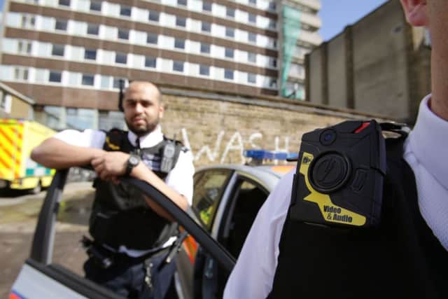 Two Metropolitan Police officers with the body-worn cameras before a year-long trial carried out by the force