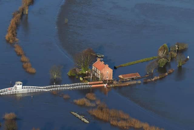 Floodwater surrounds houses in Cawood, North Yorkshire after the River Ouse burst its banks.  Joe Giddens/PA Wire