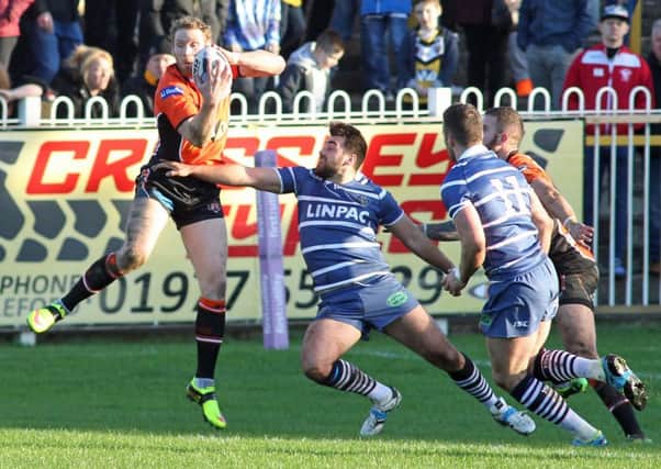Joel Monaghan takes possession of the ball for Castleford Tigers against Featherstone Rovers.