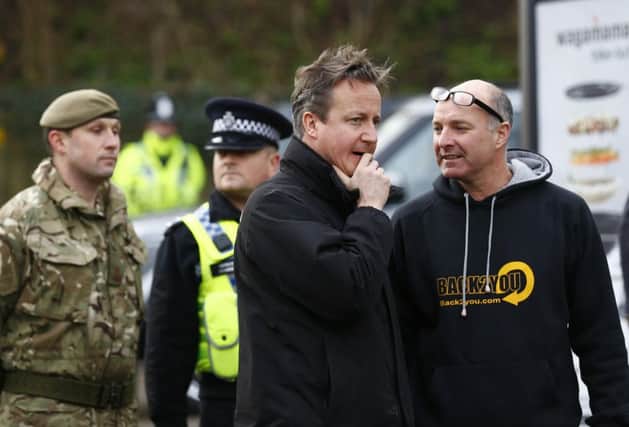 Prime Minister David Cameron talks to a resident in York today. Picture by Darren Staples/PA Wire