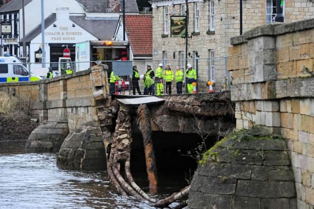 Police and Agency staff stand at the entrance to the historic Tadcaster Bridge which has partially collapsed.
 (Picture: Anthony Chappel-Ross)