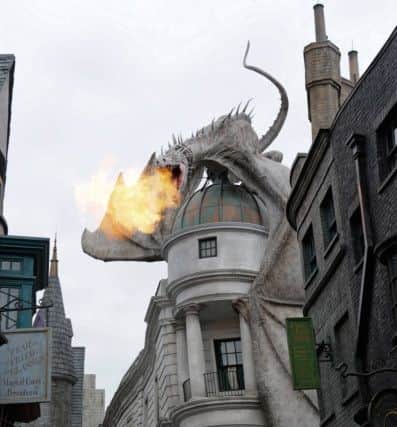 A Ukrainian Ironbelly dragon breathing fire from the top of Gringotts Bank, The Wizarding World of Harry Potter - Diagon Alley, in Universal Studios Florida Park.