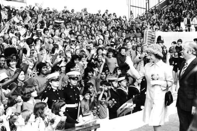 The Queen waves to a sea of children at Elland Road in July 1977.