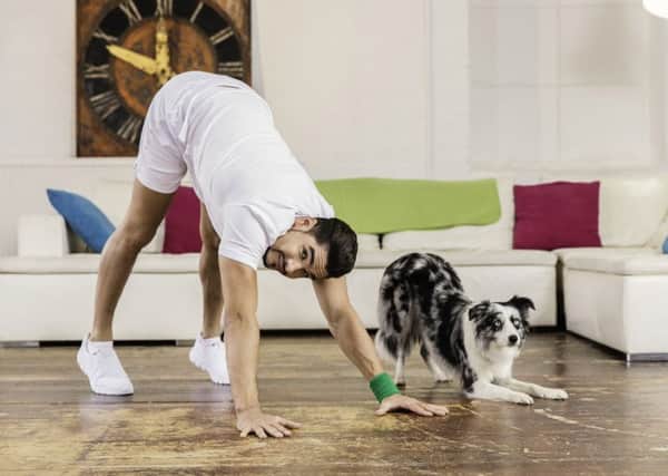 Olympian Louis Smith limbers up with Gift the dog as part of the world's first celebrity workout video for man and dog.