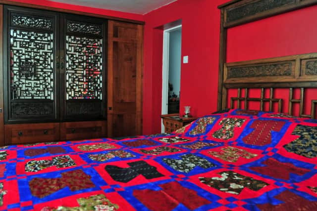 The main bedroom  with Chinese cabinet doors incorporated into the wardrobe and a quilt made by Marlene, featuring mini kiminos.
