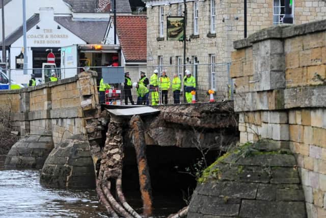 Police and Agency staff stand at the entrance to the historic Tadcaster Bridge which has partially collapsed.
Picture: Anthony Chappel-Ross