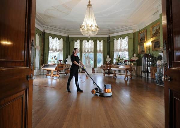 Laurence Waterhouse cleaning in the Drawing Room.
