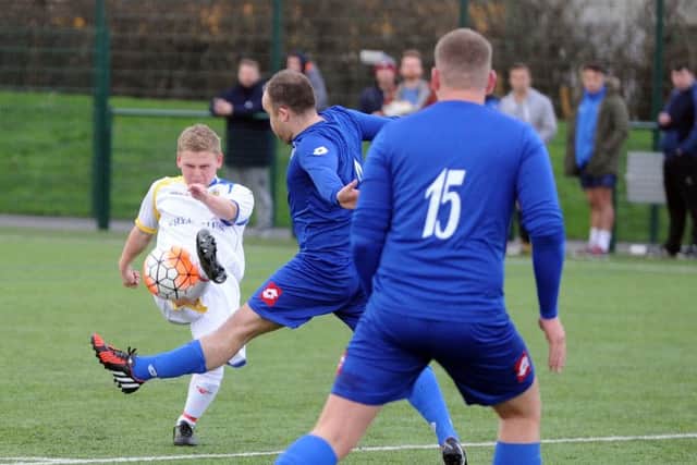 Conor Firth, of Gildersome Spurs, gets a shot away against Morley Town AFC Reserves. PIC: Steve Riding