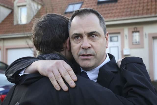Rob Lawrie hugs a supporter before a hearing at the Tribunal de Grande Instance in Boulogne
