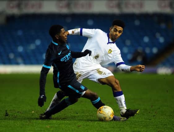 United's Matty Downing takes on City's Isaac Buckley-Ricketts.