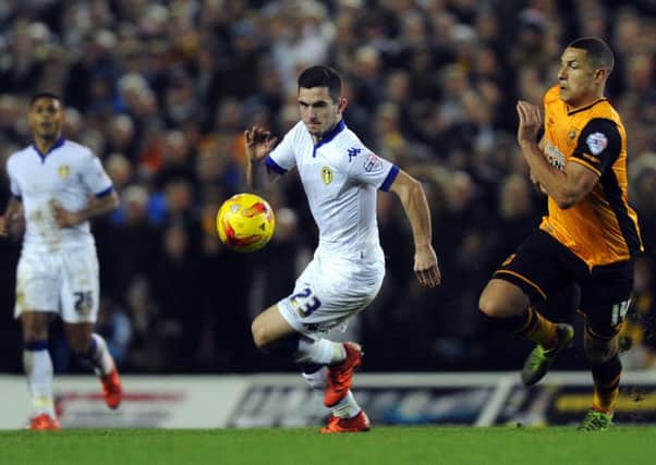 Lewis Cook takes on Hull's Jake Livermore.