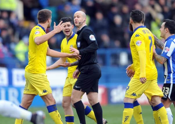 Scott Wootton and Alex Mowatt argue with referee Anthony Taylor after Liam Coopers goal was disallowed.