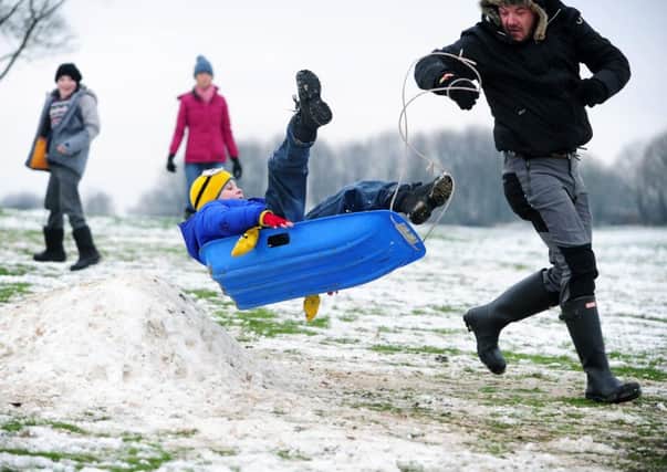 Children playing in the snow at Temple Newsam. Pictured Ewan Thomas from Cross Gates, takes off with the help of Adam Dykes.
17th January 2016.
Picture Jonathan Gawthorpe.