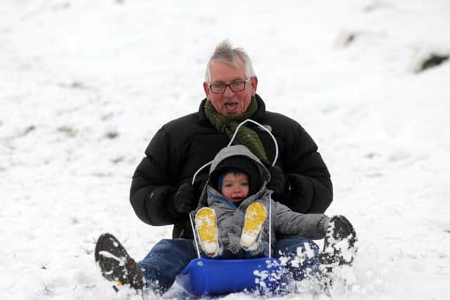 Louis Mcguire, aged two, with her grandad Charlie McDowall, enjoy the snow at Ilkley Moor..17th January 2016 ..Picture by Simon Hulme