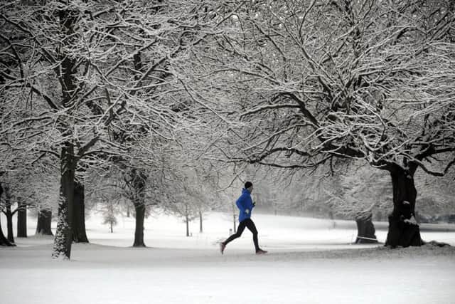 A runner runs through the snow at the Yorkshire Sculpture Park, near Wakefield..17th January 2016 ..Picture by Simon Hulme