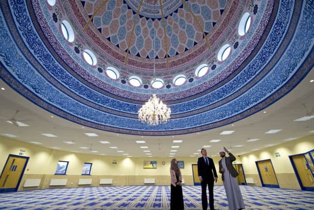David Cameron talks to Imam Qari Asim and Shabana Muneer, a member of Makkah Masjid Mosque's women's group, during a visit to the  mosque in Leeds
